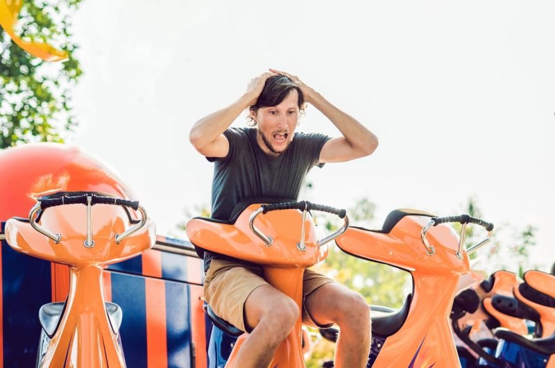 Beautiful, young man having fun at an amusement park.